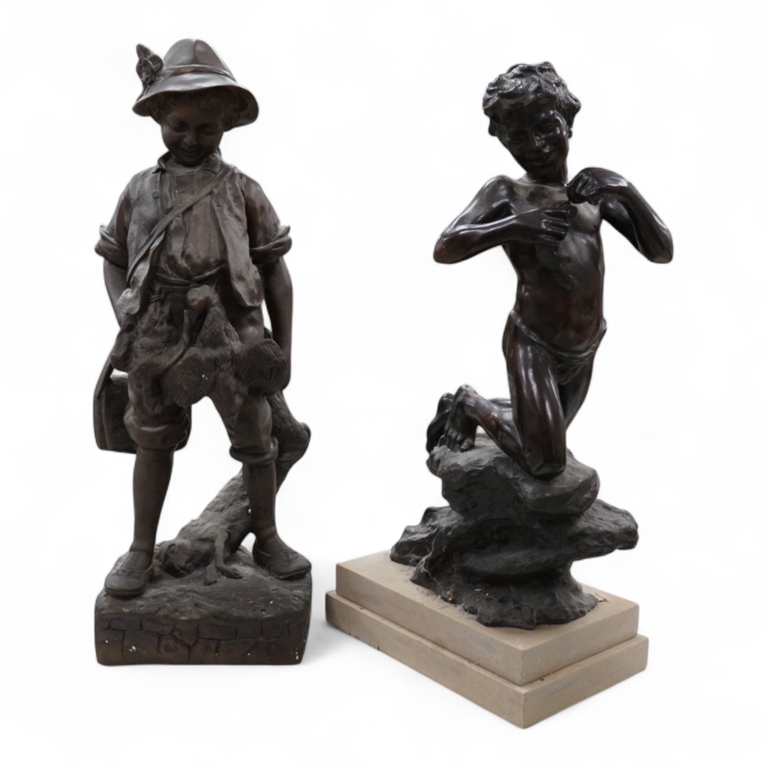 A bronze figure of a young boy carrying dead game, signed August, and a classic bronze of a young boy holding a fish, indistinctly signed, largest 53cm high